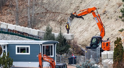 PHOTOS: Excavator goes to work on 'unstable rock' situation at Penticton mobile home park